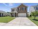 Charming two-story home with a brick facade, well-manicured lawn, and inviting front porch at 110 Levis Song Ct, Goose Creek, SC 29445