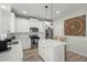 Modern kitchen featuring white cabinetry, stainless steel appliances, and a central island with seating at 110 Levis Song Ct, Goose Creek, SC 29445