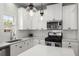 Well-lit kitchen with white cabinets, subway tile backsplash, and stainless steel appliances at 110 Levis Song Ct, Goose Creek, SC 29445