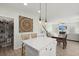 Spacious kitchen with white island, dining area, and cozy living room in the background at 110 Levis Song Ct, Goose Creek, SC 29445