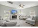 Open-concept living room filled with natural light, featuring a sectional sofa and cozy fireplace at 110 Levis Song Ct, Goose Creek, SC 29445