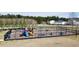Community playground with various play structures and picnic tables surrounded by a black metal fence at 110 Levis Song Ct, Goose Creek, SC 29445