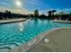 Close-up view of the community pool with clear blue water, lounge chairs, and an umbrella for shade at 110 Levis Song Ct, Goose Creek, SC 29445