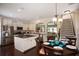 Open-concept kitchen with stainless steel appliances, an island, and adjacent dining area at 113 Crosscut Ln, Summerville, SC 29486