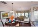 Cozy dining area with hardwood floors, large windows, and stylish furnishings, adjacent to the living room at 113 Crosscut Ln, Summerville, SC 29486