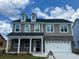Charming two-story home with a brick and siding exterior and a well-manicured front yard at 113 Crosscut Ln, Summerville, SC 29486