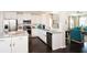 Modern kitchen with white cabinetry, stainless steel appliances, and an open layout to the living area at 113 Crosscut Ln, Summerville, SC 29486
