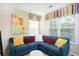 Comfortable sitting area with a blue sectional couch, colorful pillows, and natural light from the windows at 113 Crosscut Ln, Summerville, SC 29486