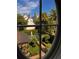 View of backyard through oval window featuring landscaping, pool, and surrounding trees at 12 Orange St, Charleston, SC 29401