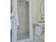 Walk in shower with decorative tilework and marble sink basin in remodeled bathroom at 12 Orange St, Charleston, SC 29401