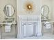 Dual sinks and a decorative fireplace with gold star decor adorn this bright bathroom at 12 Orange St, Charleston, SC 29401