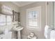 Stylish bathroom features pedestal sink, modern fixtures, and ample natural light at 12 Orange St, Charleston, SC 29401