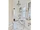 Bright, remodeled bathroom with and sinks and vintage light fixtures at 12 Orange St, Charleston, SC 29401