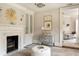 Inviting bedroom with fireplace, chandelier, and view into an adjoining sitting room at 12 Orange St, Charleston, SC 29401