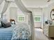 Light-filled bedroom features a decorative mirror and canopy bed at 12 Orange St, Charleston, SC 29401