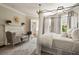 Bedroom showcasing a fireplace, seating area, four-poster bed, and beautiful windows at 12 Orange St, Charleston, SC 29401