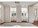 Bright bedroom with hardwood floors, built-in closets, and french doors to a garden at 12 Orange St, Charleston, SC 29401