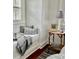 Cozy bedroom nook featuring comfortable window seat with throw pillows and blanket at 12 Orange St, Charleston, SC 29401