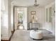Bright bedroom with fireplace and entry into an adjoining sitting area with blue furniture at 12 Orange St, Charleston, SC 29401