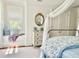 Bright bedroom features a window seat, decorative mirror, and stylish furnishings at 12 Orange St, Charleston, SC 29401