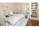 Comfortable bedroom featuring a bed, seating bench, and built in shelving unit at 12 Orange St, Charleston, SC 29401