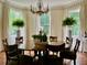 Chandelier-lit dining area featuring table, and herringbone wood floors at 12 Orange St, Charleston, SC 29401