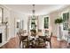 Bright dining area featuring chandelier, table, and herringbone wood floors at 12 Orange St, Charleston, SC 29401