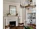Formal dining area featuring fireplace, table, and herringbone wood floors at 12 Orange St, Charleston, SC 29401