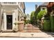 Exterior shot of home entrance with gated, brick-paved walkway, and lush landscaping at 12 Orange St, Charleston, SC 29401