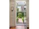 Welcoming entryway opens to a serene garden view with brick pathway and manicured hedges at 12 Orange St, Charleston, SC 29401