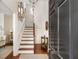 Entryway with hardwood floors, staircase, and decorative mirrors on the wall at 12 Orange St, Charleston, SC 29401