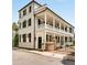Charming two-story home with a beautiful porch, black shutters, and a gated entrance at 12 Orange St, Charleston, SC 29401
