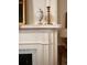 Close-up of fireplace mantle with stylish decorative items and white wood trim at 12 Orange St, Charleston, SC 29401