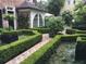 Lush manicured garden with brick pathways and meticulously shaped hedges at 12 Orange St, Charleston, SC 29401