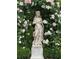 Garden statue surrounded by pink and white roses at 12 Orange St, Charleston, SC 29401