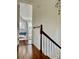 Bright hallway leads to a bedroom with a canopy bed and natural light at 12 Orange St, Charleston, SC 29401