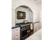 Close up of gourmet kitchen with professional-grade black range, custom cabinets, and marble backsplash at 12 Orange St, Charleston, SC 29401
