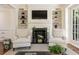 Elegant living room featuring a fireplace with built-in bookshelves and comfortable seating at 12 Orange St, Charleston, SC 29401