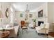 Bright living room with fireplace, chandelier, and elegant furnishings at 12 Orange St, Charleston, SC 29401