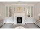 Elegant living room featuring a marble fireplace, chandelier and built-in mirrored cabinets at 12 Orange St, Charleston, SC 29401