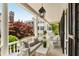 Spacious porch with wicker furniture offers relaxing views of the lush surroundings at 12 Orange St, Charleston, SC 29401