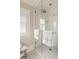Modern shower with white subway tile and glass doors, showcasing elegant design at 12 Orange St, Charleston, SC 29401