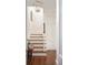 Bright staircase with wooden steps and floors, featuring a hanging light fixture at 12 Orange St, Charleston, SC 29401