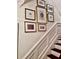 Close up of staircase with dark wood treads and decorative artwork on the wall at 12 Orange St, Charleston, SC 29401