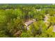 Expansive aerial view of a home nestled among lush, dense trees, showcasing its serene, nature-filled environment at 120 Perry Hill Rd, Moncks Corner, SC 29461