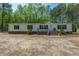 Delightful single-story home with a welcoming porch, framed by beautiful landscaping and a backdrop of natural greenery at 120 Perry Hill Rd, Moncks Corner, SC 29461