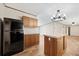 Well-lit kitchen with island, wooden cabinets, and black refrigerator at 120 Perry Hill Rd, Moncks Corner, SC 29461