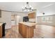 Well-lit kitchen with central island, modern appliances, and adjacent laundry area at 120 Perry Hill Rd, Moncks Corner, SC 29461