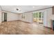 Bright living room featuring wood floors, a ceiling fan, and sliding glass door to the backyard at 120 Perry Hill Rd, Moncks Corner, SC 29461
