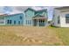 New home backyard with green siding, highlighting the backyard patio and spacious lawn at 1238 Homecoming Blvd Blvd, Ravenel, SC 29470